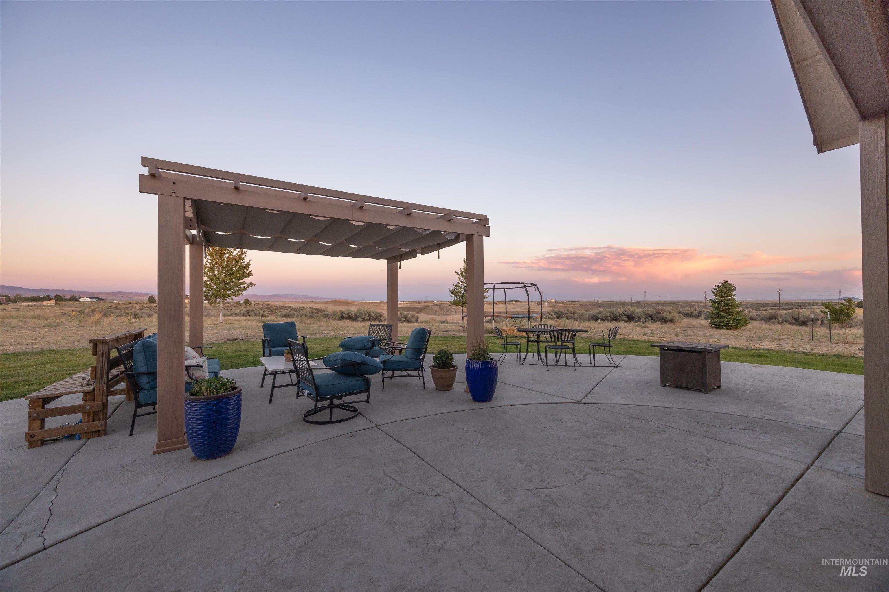 View of patio with an outdoor living space and a view of countryside