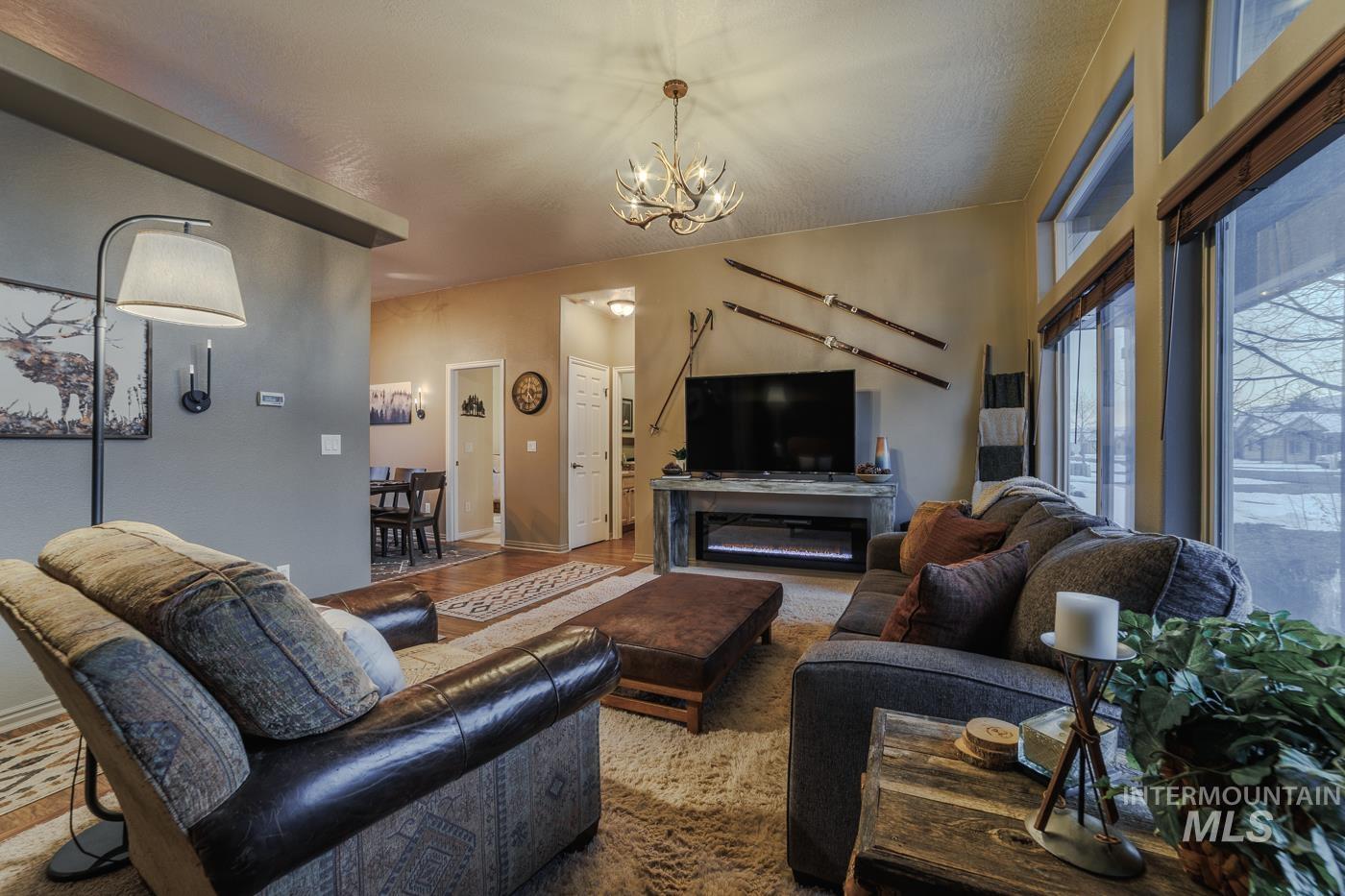 Living area with suspended lighting and wood finished floors