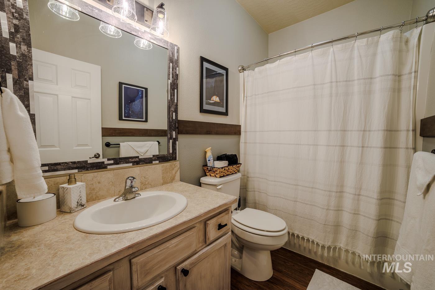 Bathroom with vanity and dark wood-style floors