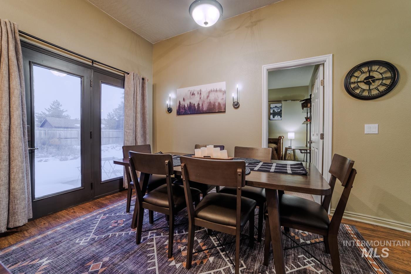 Dining room featuring dark wood finished floors and baseboards