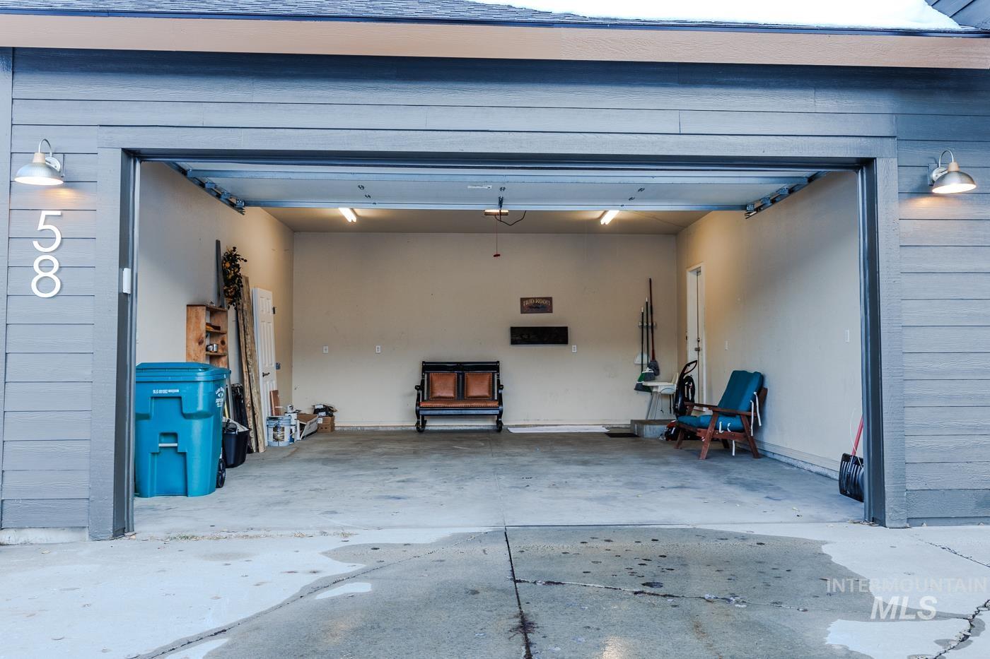 Garage featuring concrete driveway