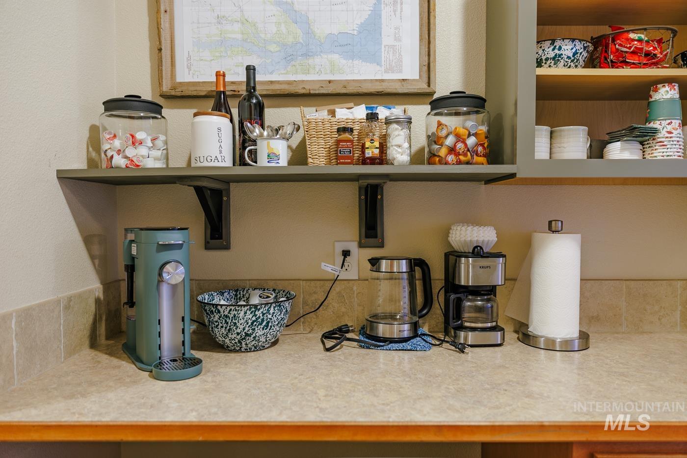 Detailed view of light countertops, open shelves, and a textured wall