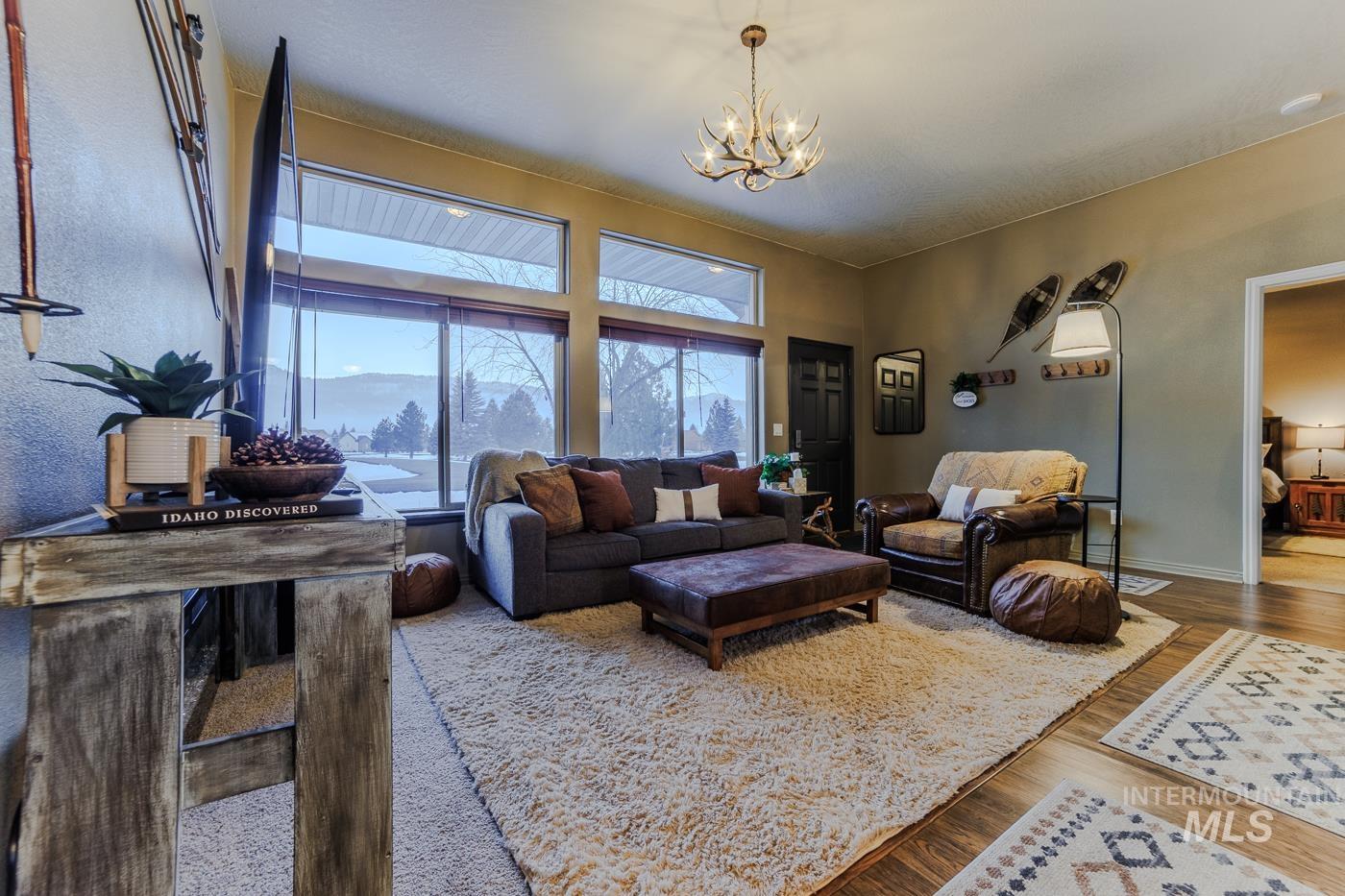 Living room featuring wood finished floors and hanging lights
