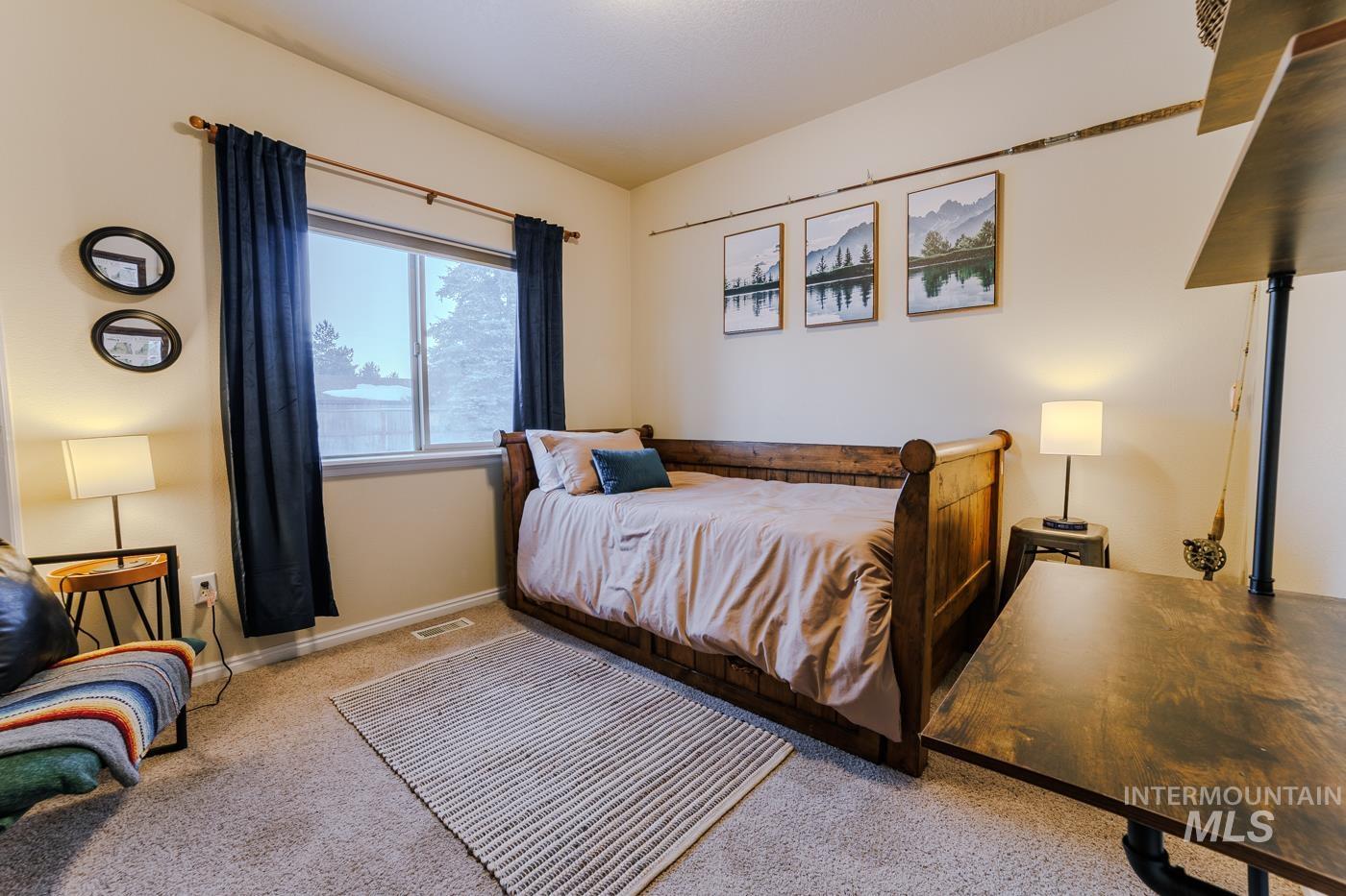 Bedroom with carpet flooring and baseboards