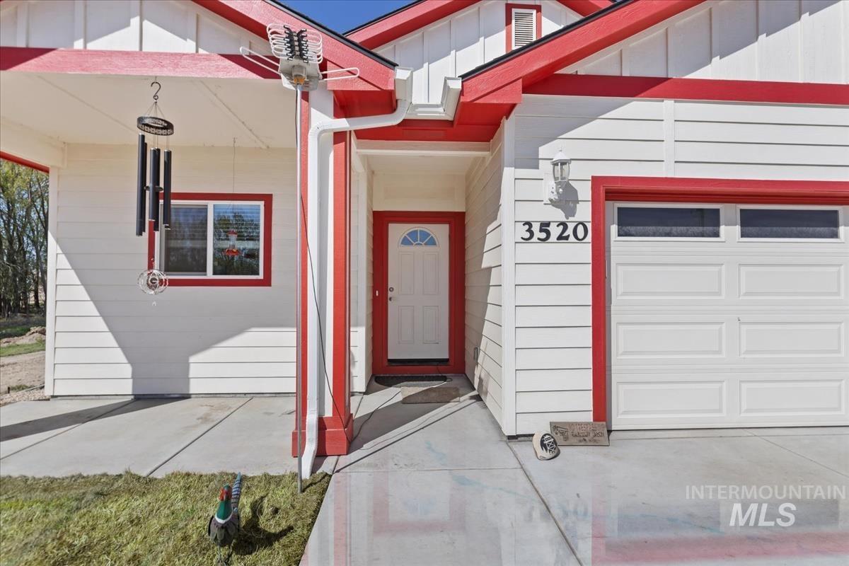 Property entrance featuring a garage and board and batten siding