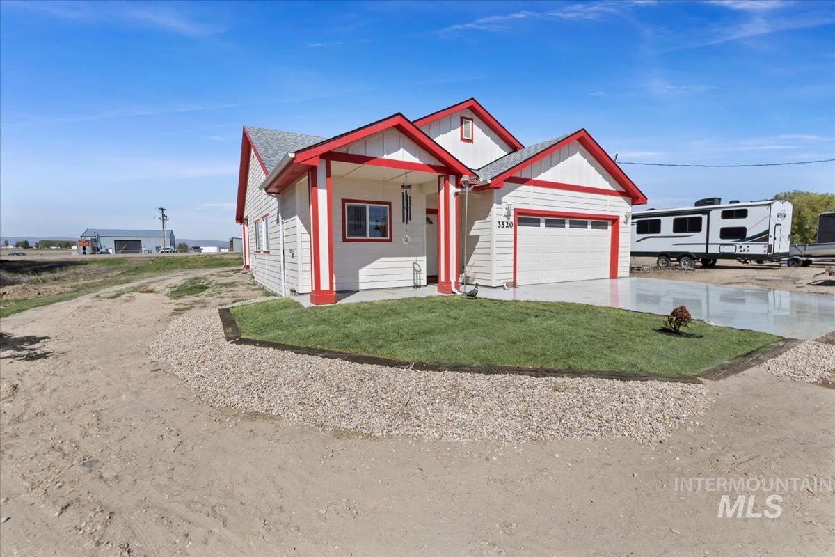 View of front of house with a front lawn, concrete driveway, a porch, and an attached garage