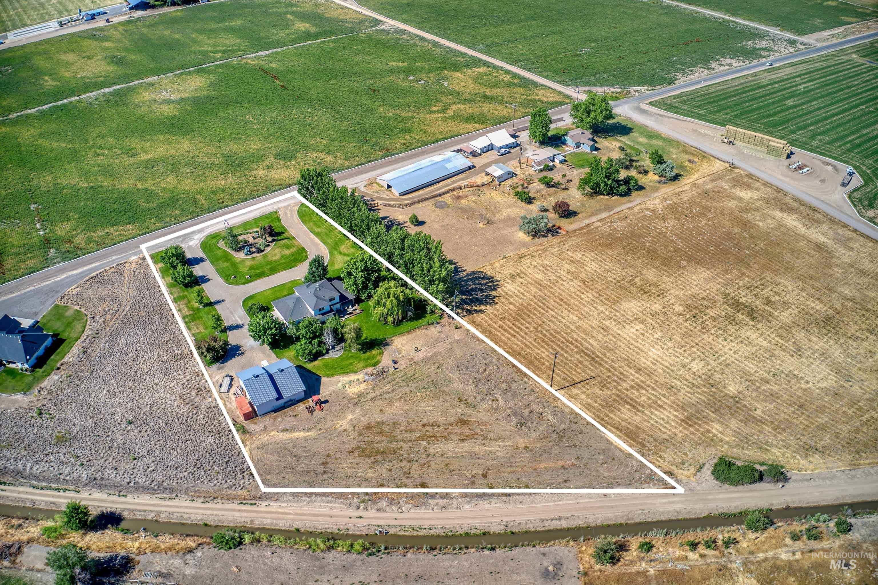 Aerial perspective showcasing a residential property with surrounding agricultural land