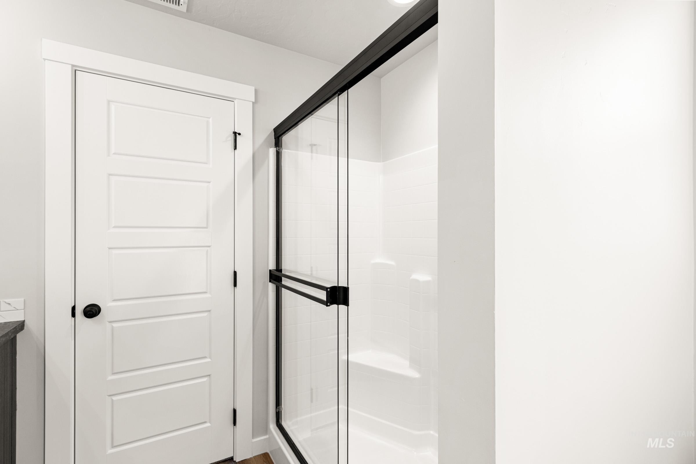 Bathroom featuring a stall shower and vanity