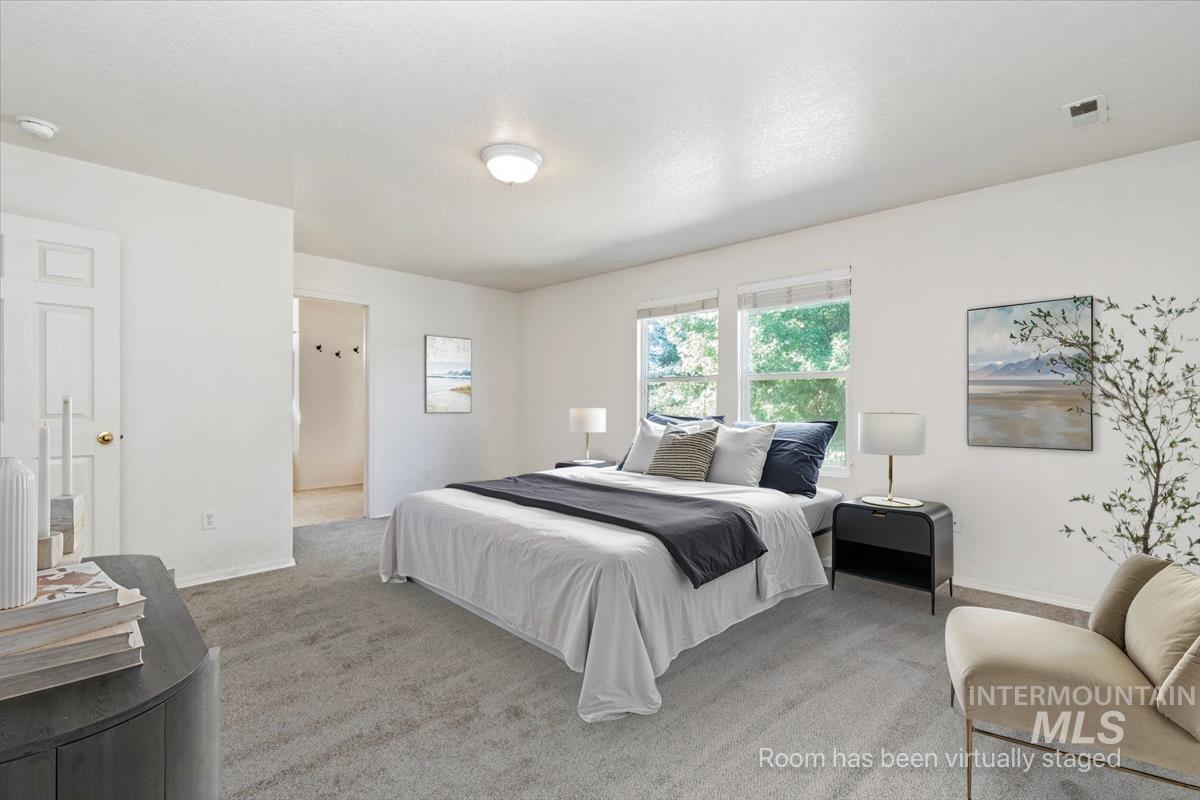Carpeted bedroom featuring baseboards