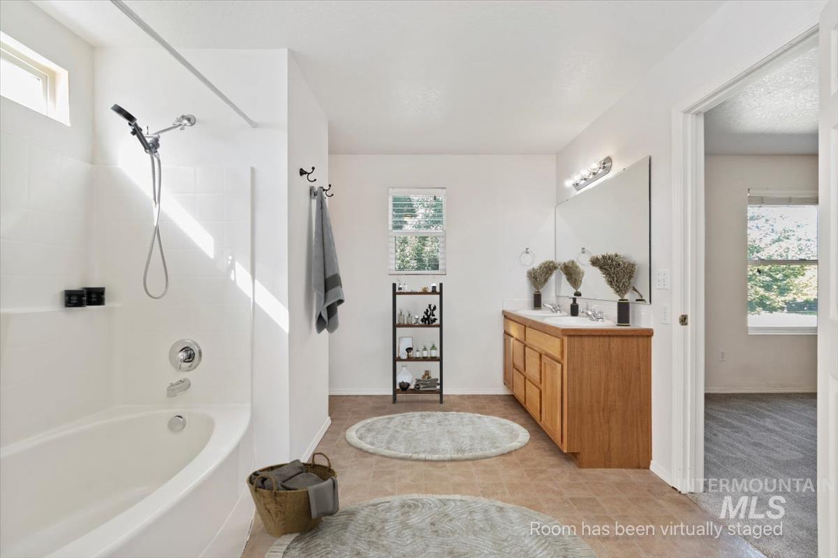 Bathroom with vanity and shower / tub combination
