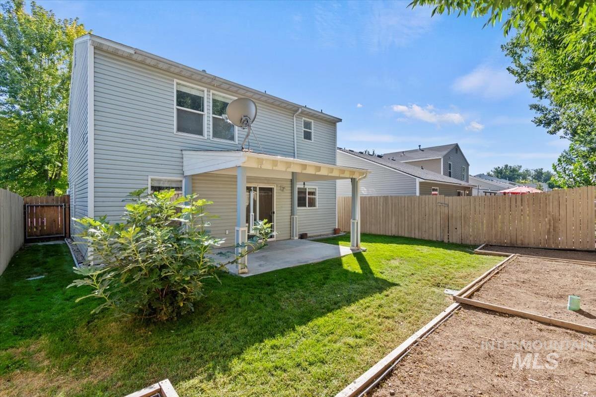 View of front of house with a garage, driveway, stone siding, and a front yard