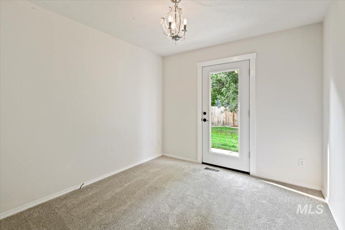 This flex room highlights new carpet and access to the backyard