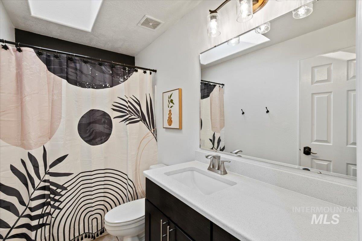 Upstairs full tub/shower bathroom with skylight