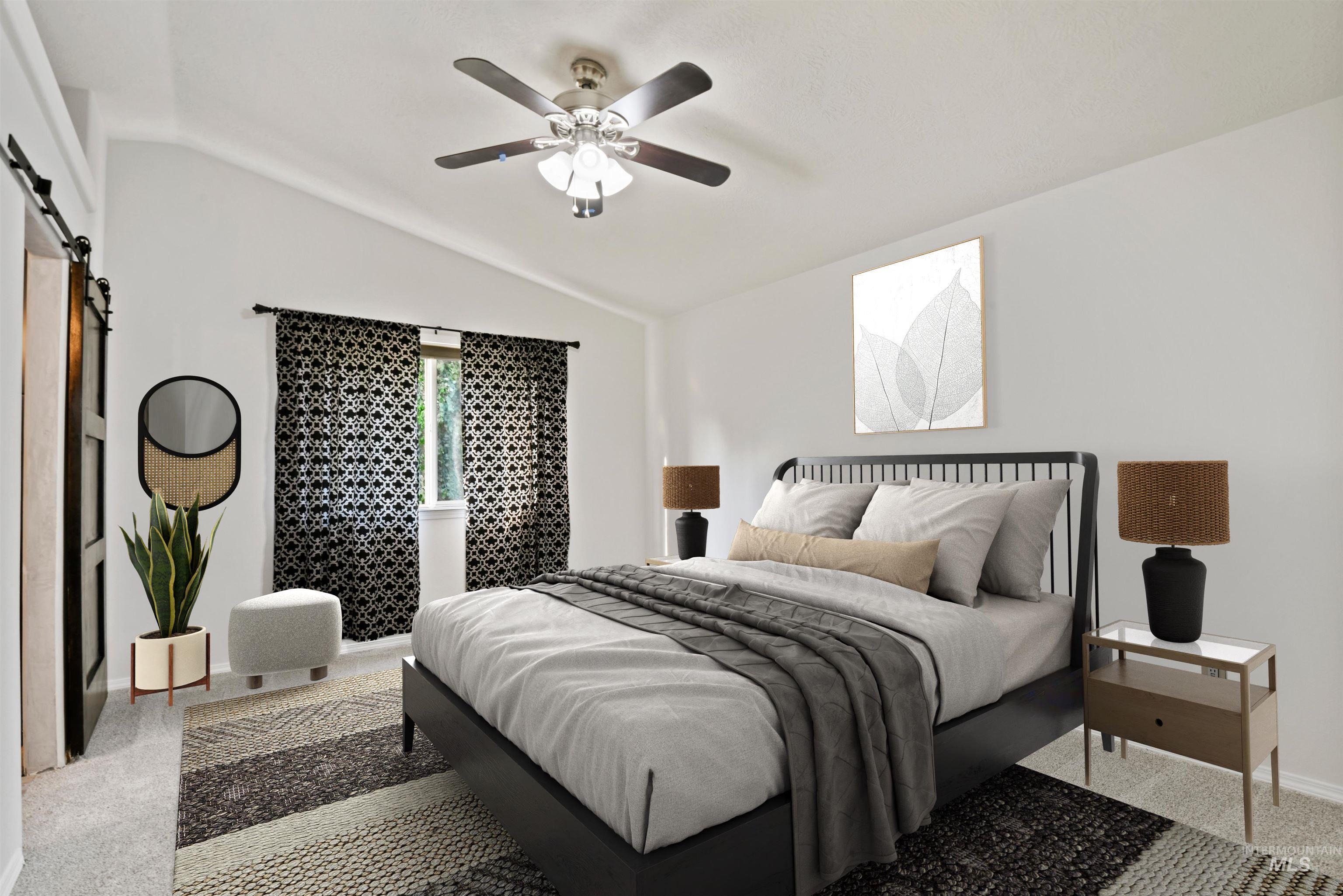 Carpeted bedroom with a barn door, lofted ceiling, and fan