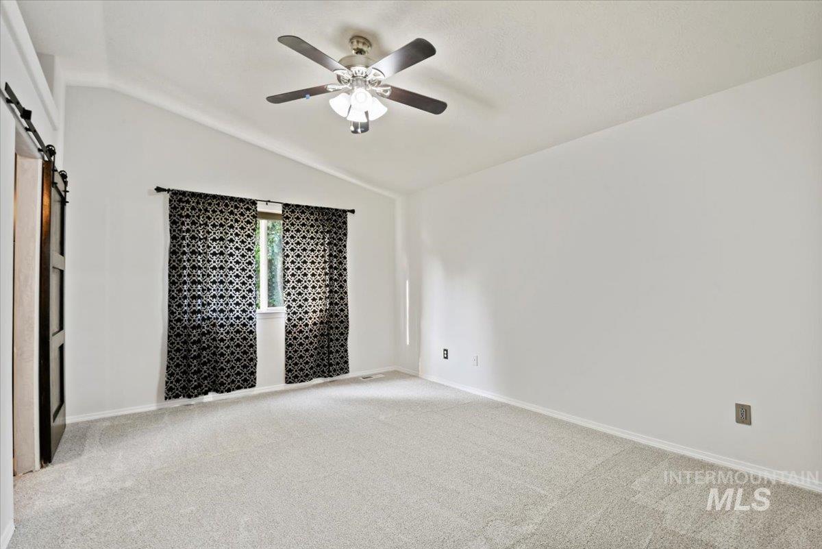 Renovated primary bedroom ensuite with barn doors to bathroom