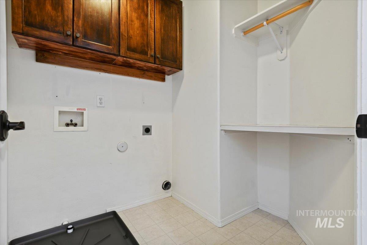 Upstairs laundry room with hookups and above cabinetry