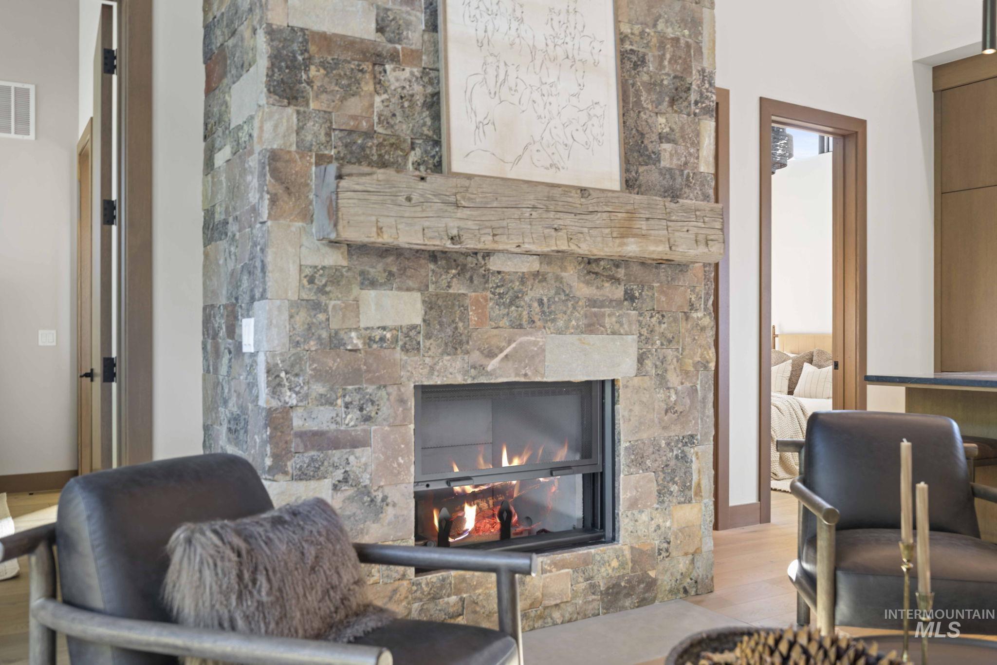 Detailed view of a glass covered fireplace and wood finished floors