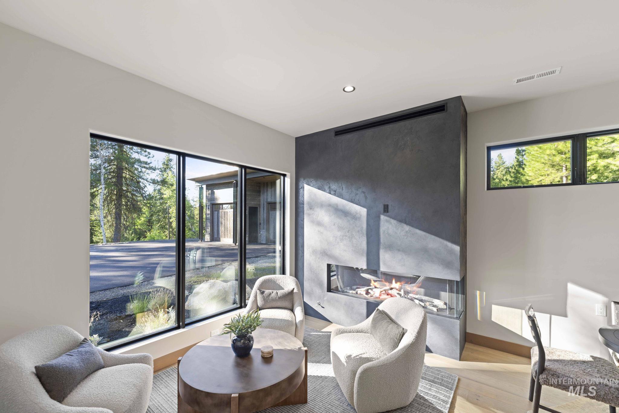 Living area with wood finished floors and recessed lighting