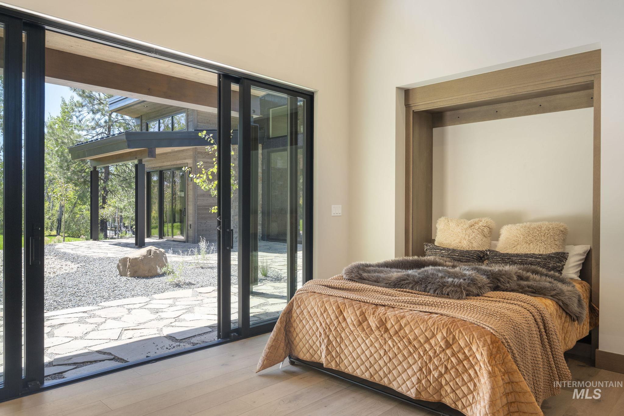 Bedroom featuring hardwood / wood-style flooring and access to exterior