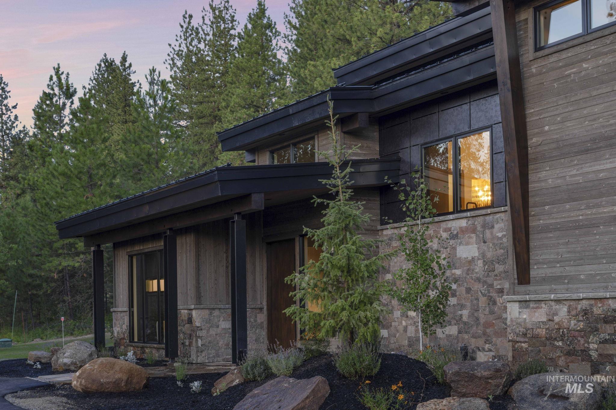 Property exterior at dusk with stone siding