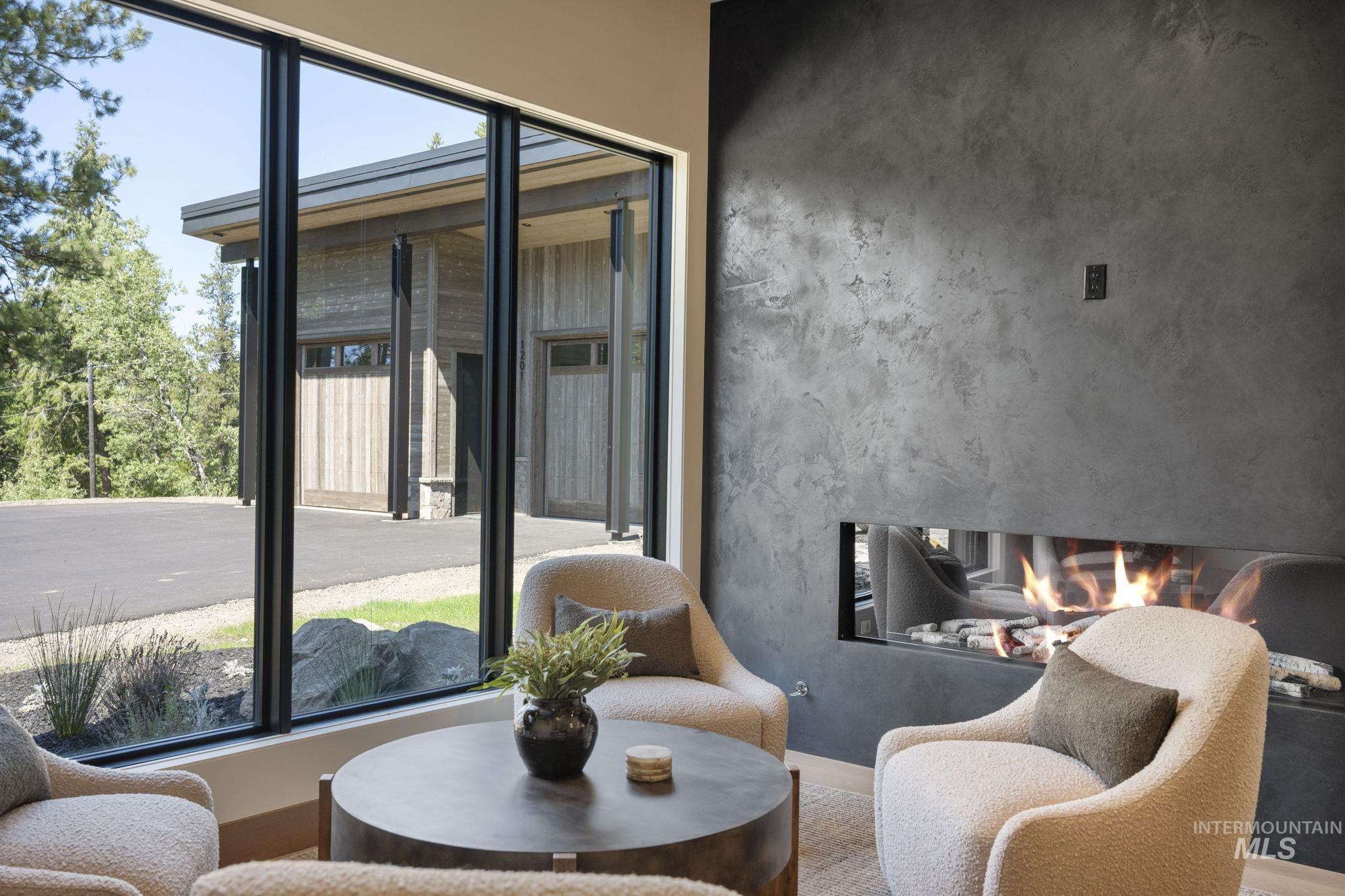 Living area with a premium fireplace, healthy amount of natural light, and wood finished floors