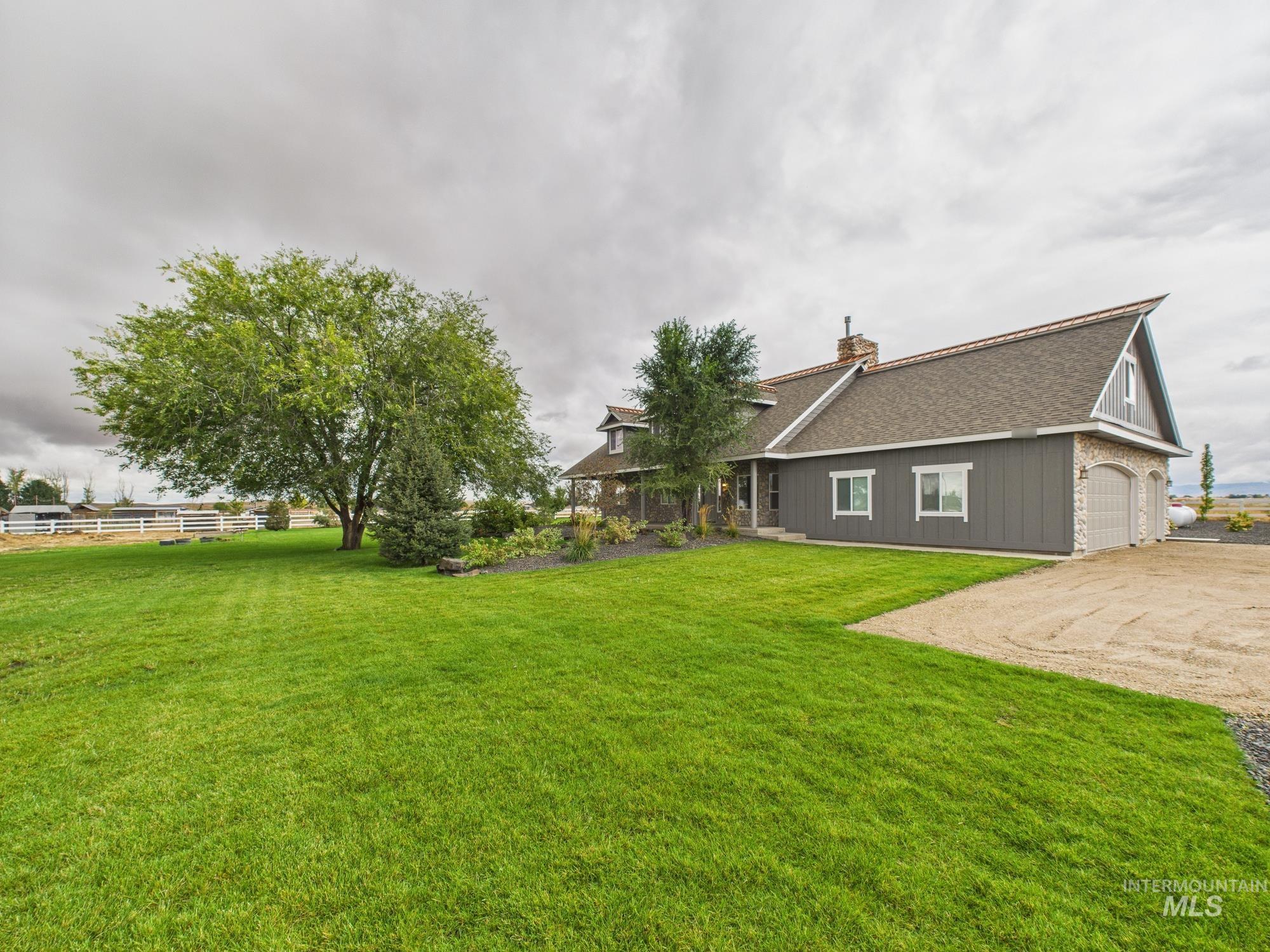 View of yard with driveway and an attached garage