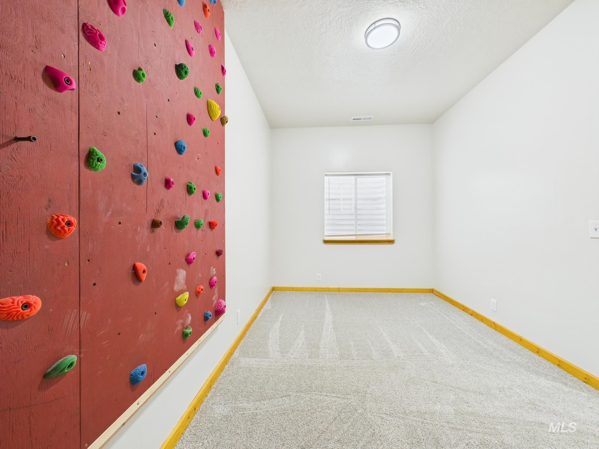 Empty room featuring carpet floors and a textured ceiling