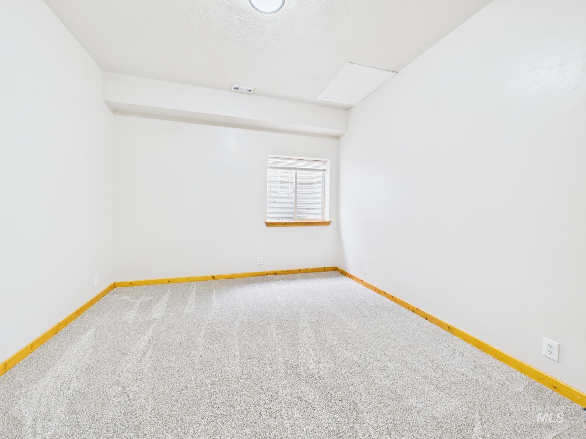 Empty room with carpet flooring and baseboards
