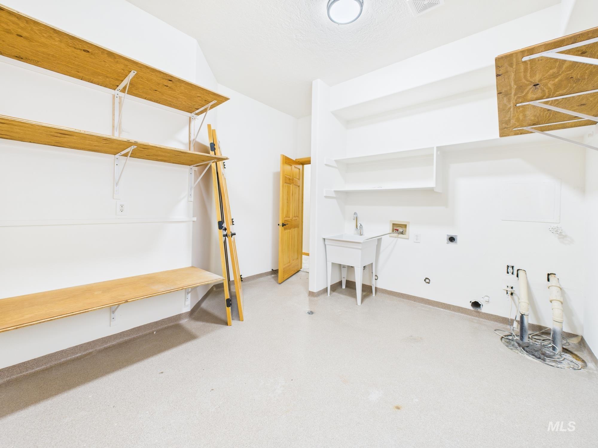 Laundry room featuring hookup for a washing machine, hookup for an electric dryer, gas dryer hookup, and finished concrete flooring