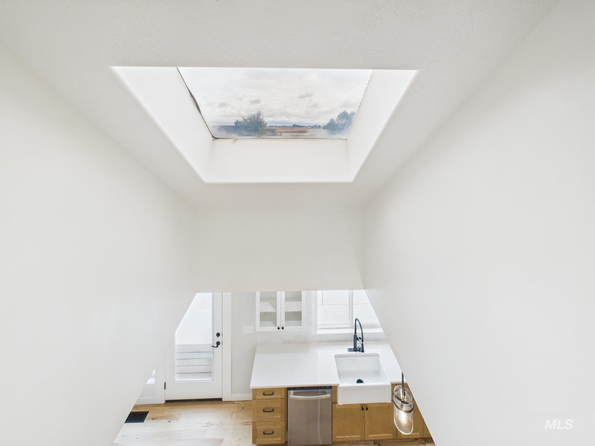 Office space featuring light wood-style floors and a skylight