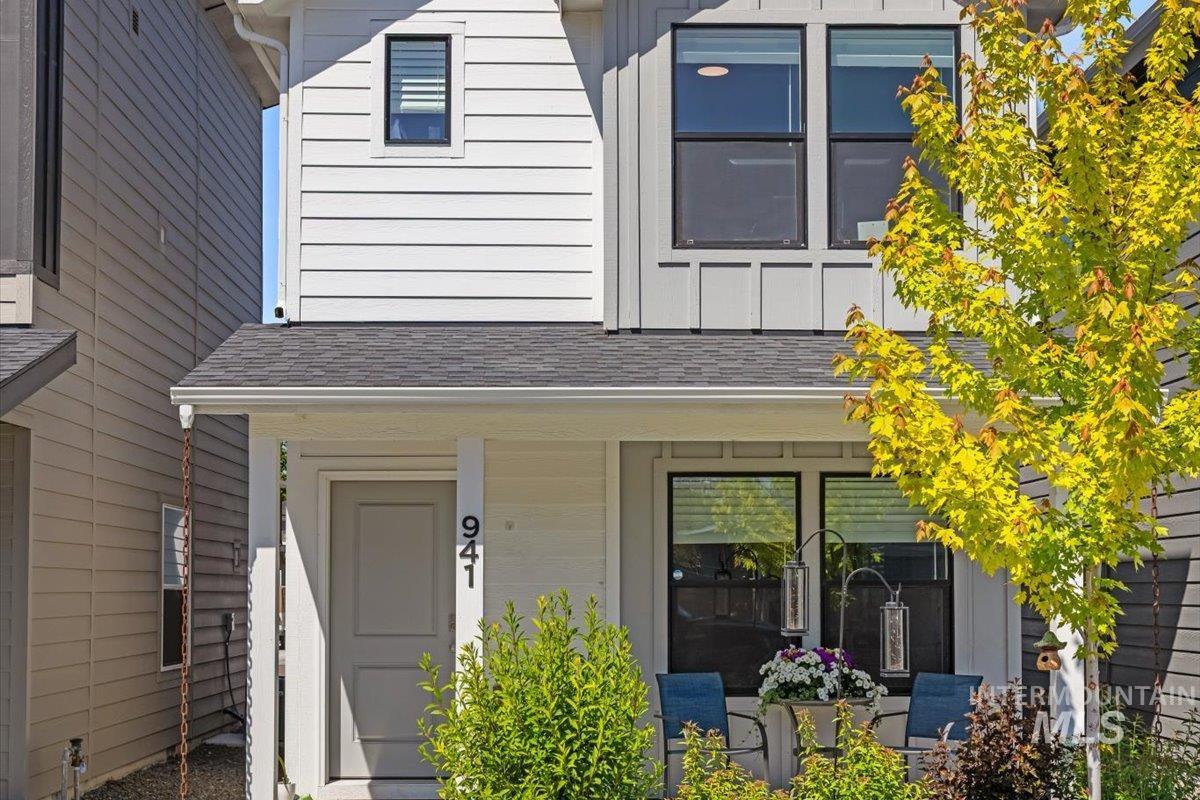 Entrance to property with roof with shingles and board and batten siding