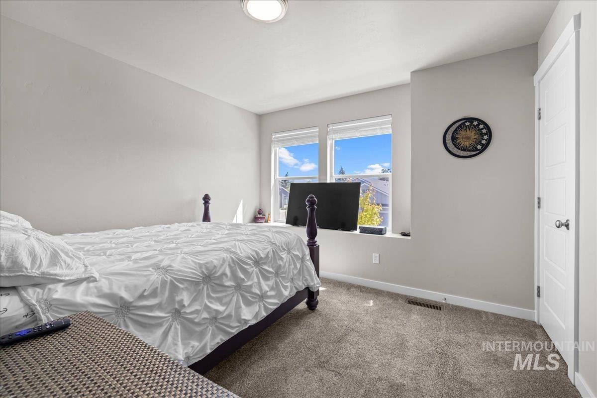 Carpeted bedroom with baseboards