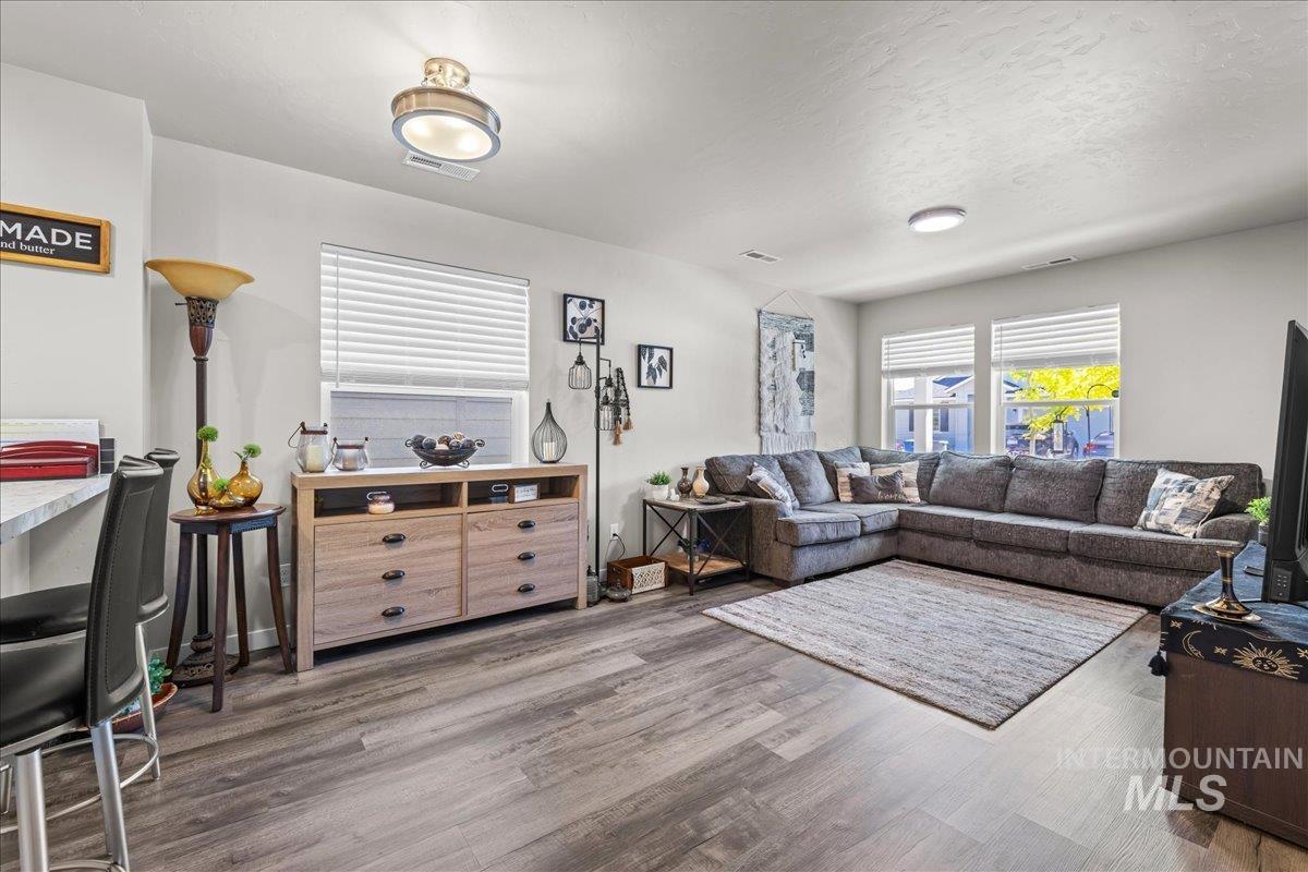 Living area featuring wood finished floors and a textured ceiling