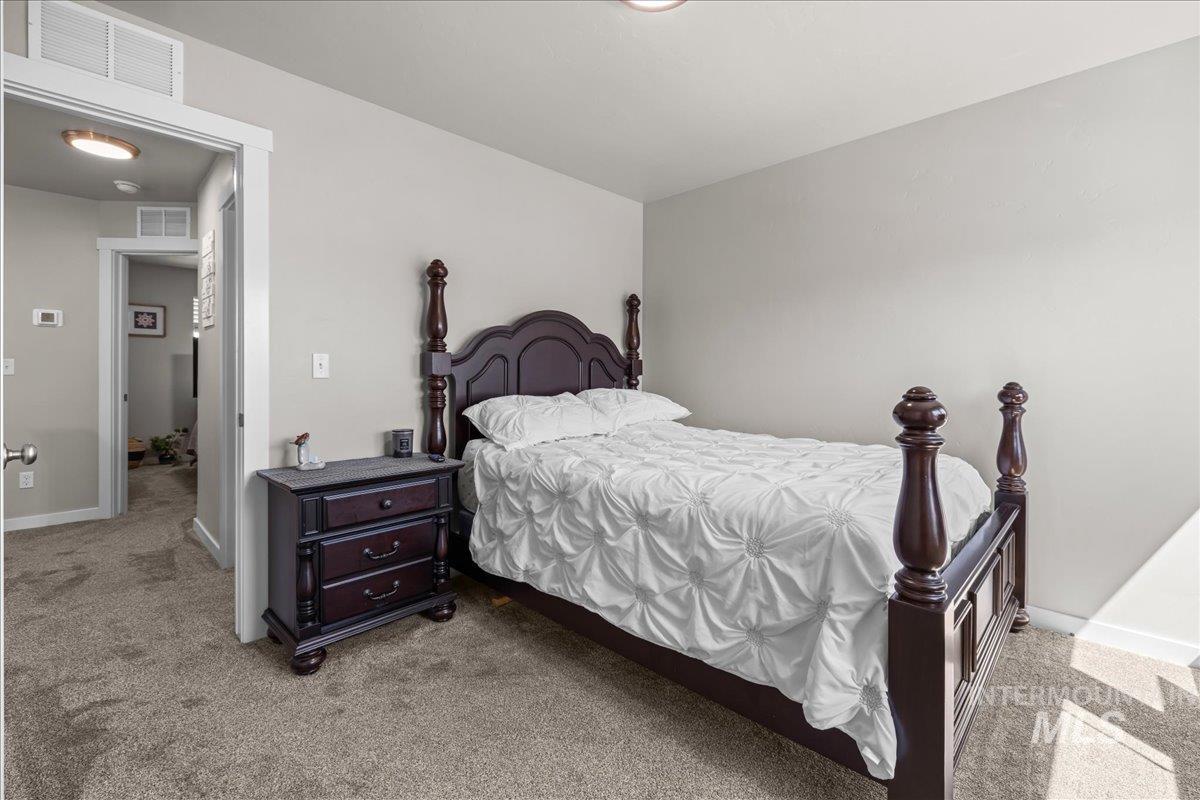 Bedroom with light carpet