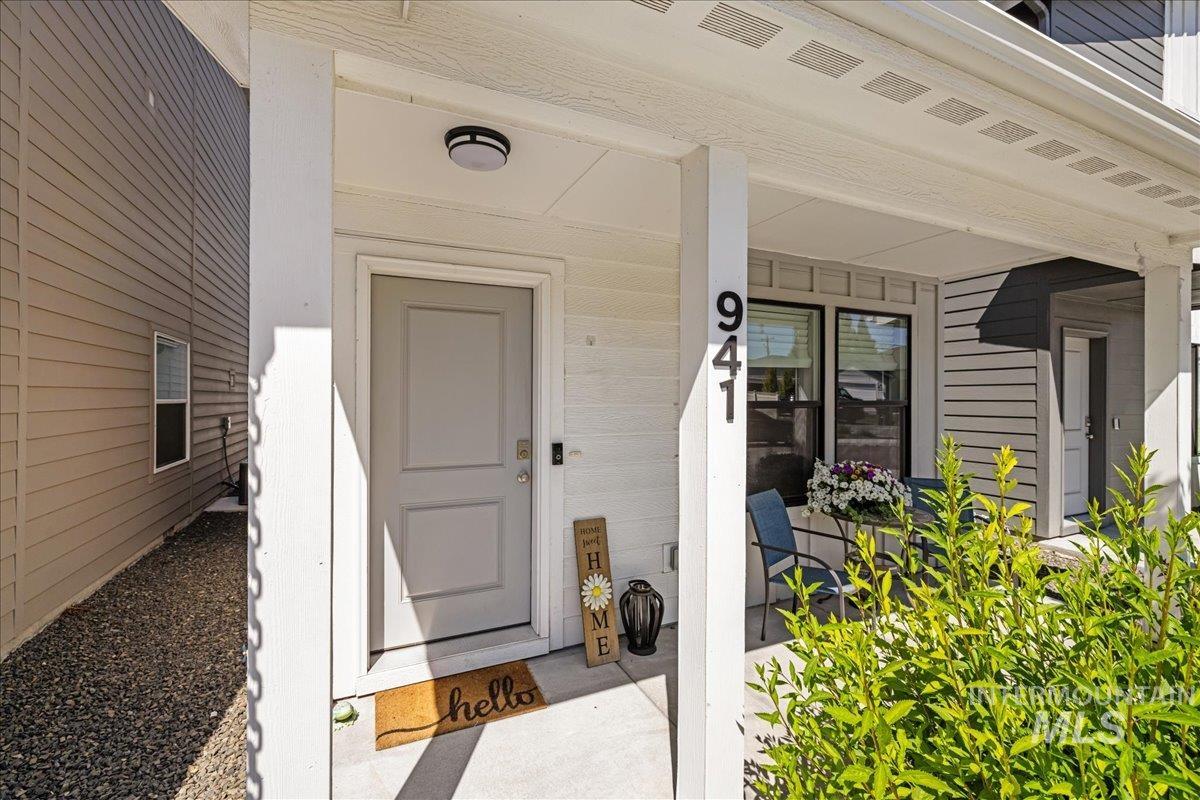 View of exterior entry featuring covered porch