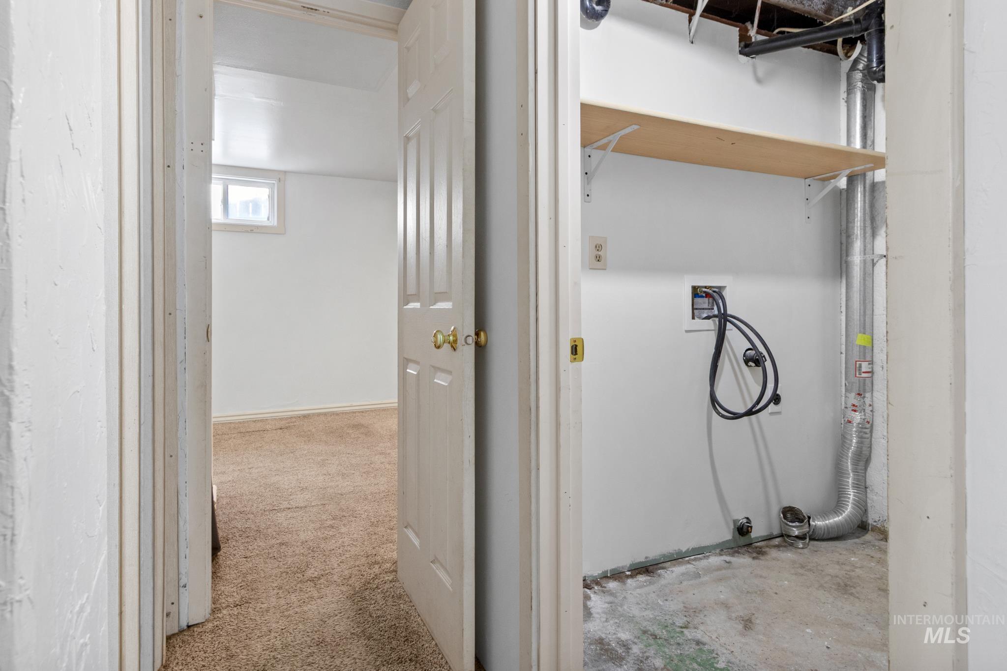 Dedicated utility space featuring a wood shelf, exposed ductwork, and electrical outlets