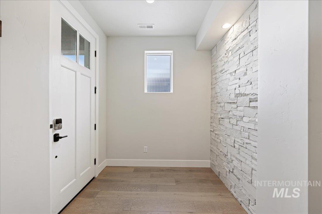 Doorway featuring wood finished floors and recessed lighting