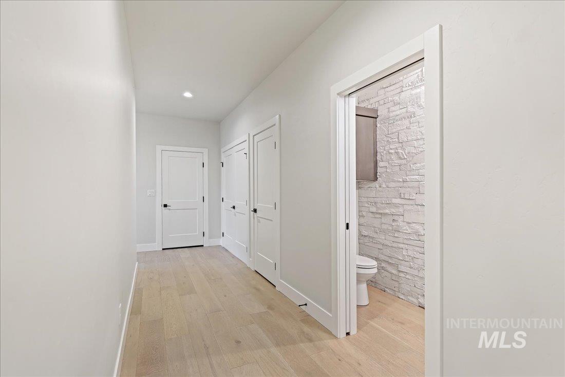 Hall featuring light wood-style floors and recessed lighting