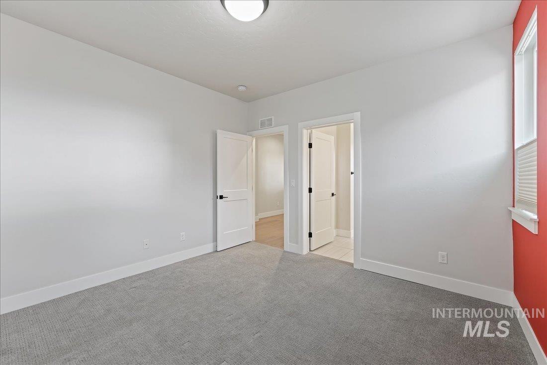 Unfurnished bedroom with baseboards and carpet floors