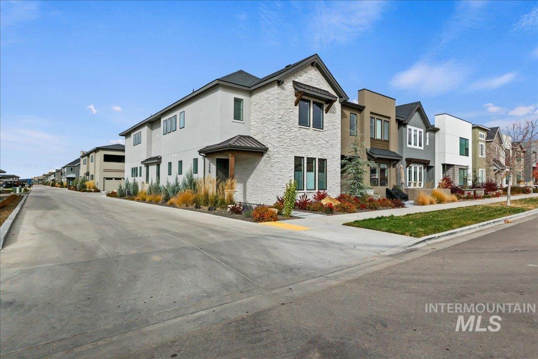 View of street featuring a residential view, curbs, and sidewalks