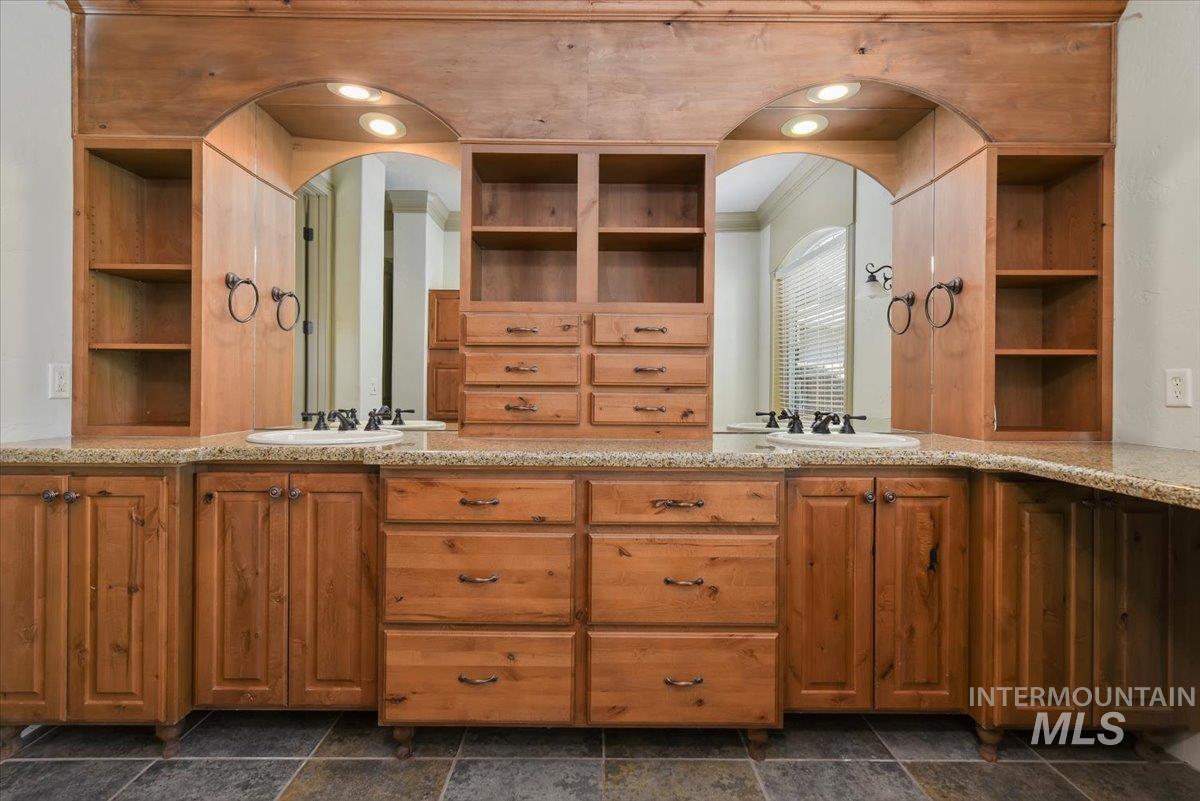 Full bathroom featuring double vanity and built in features