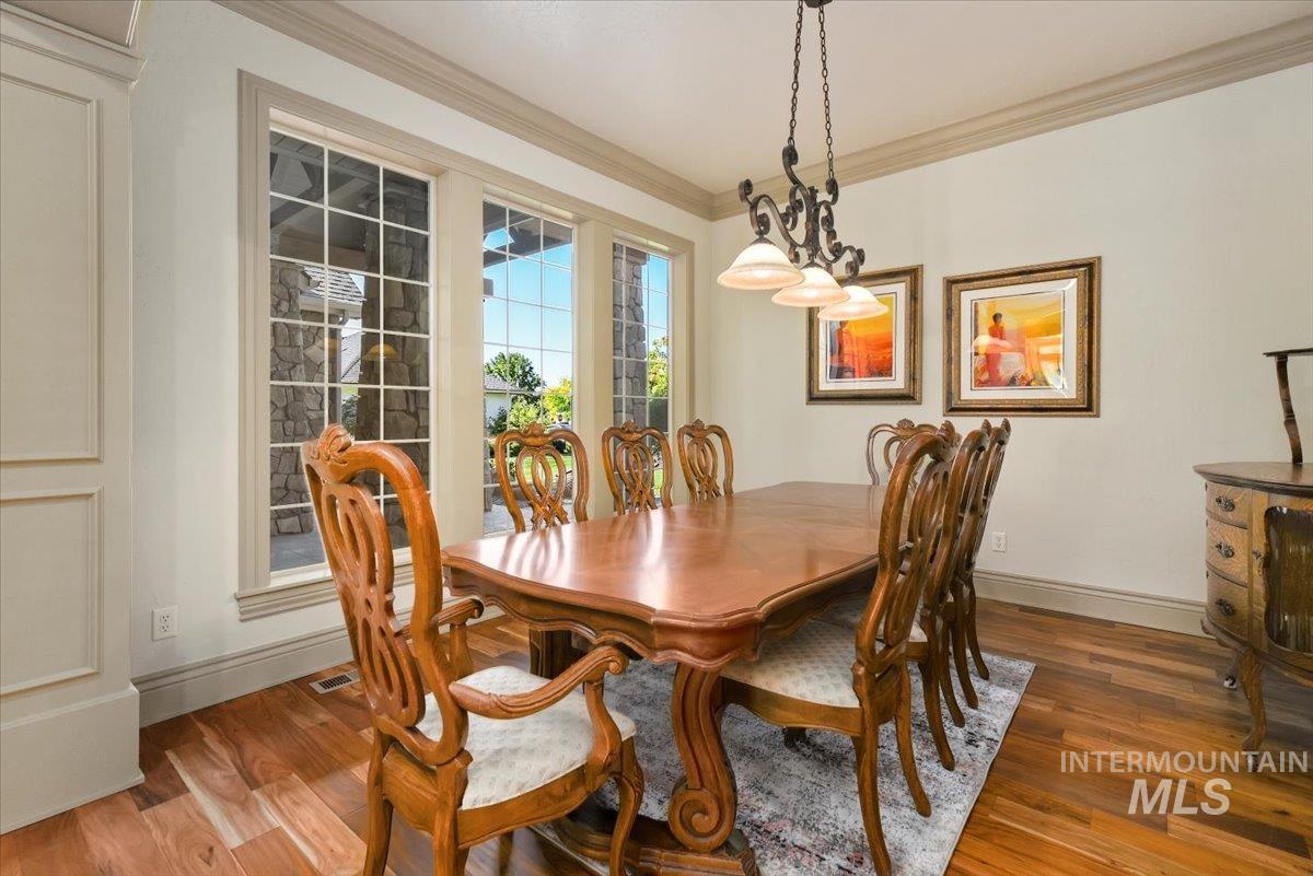 Dining room featuring crown molding and wood finished floors