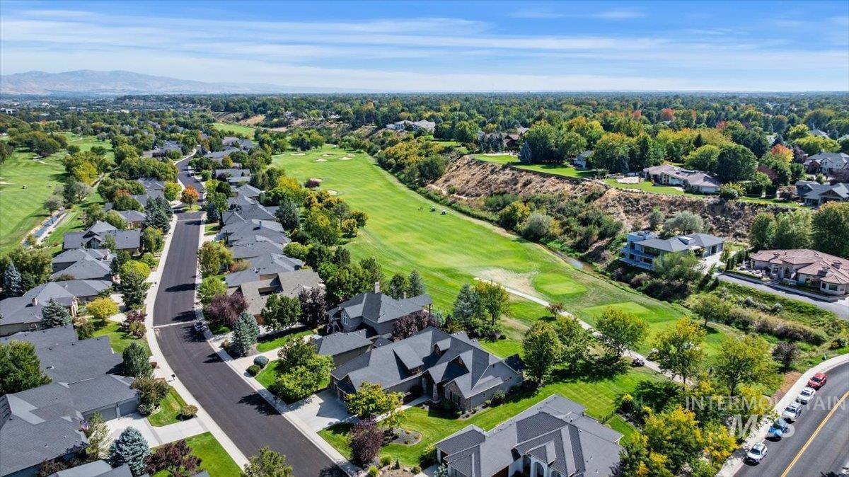 Aerial overview of property's location with a local golf course and nearby suburban area