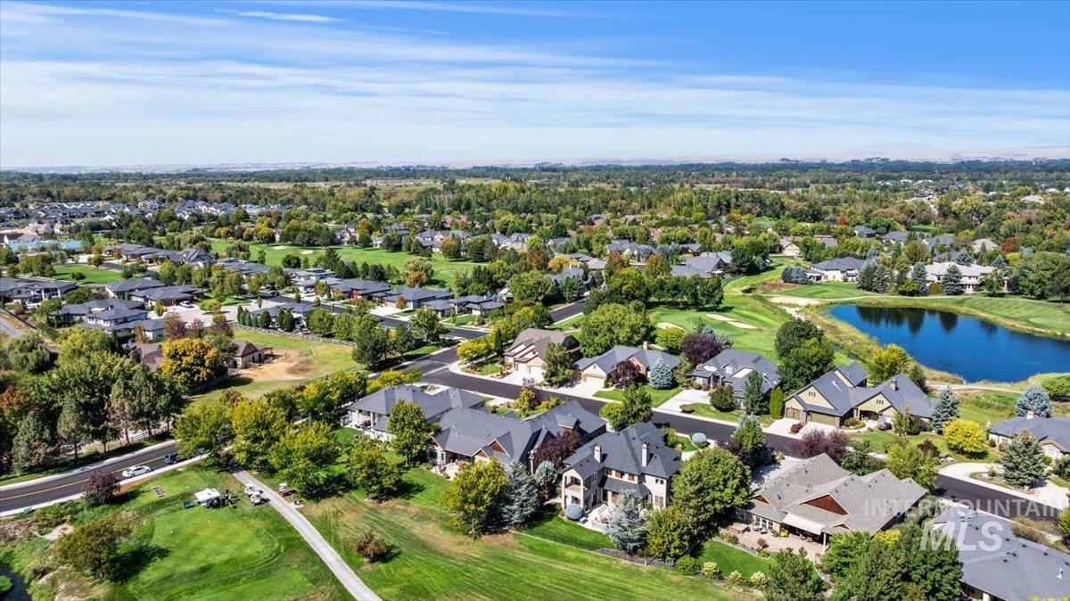 Aerial perspective of suburban area with a large body of water and a local golf course