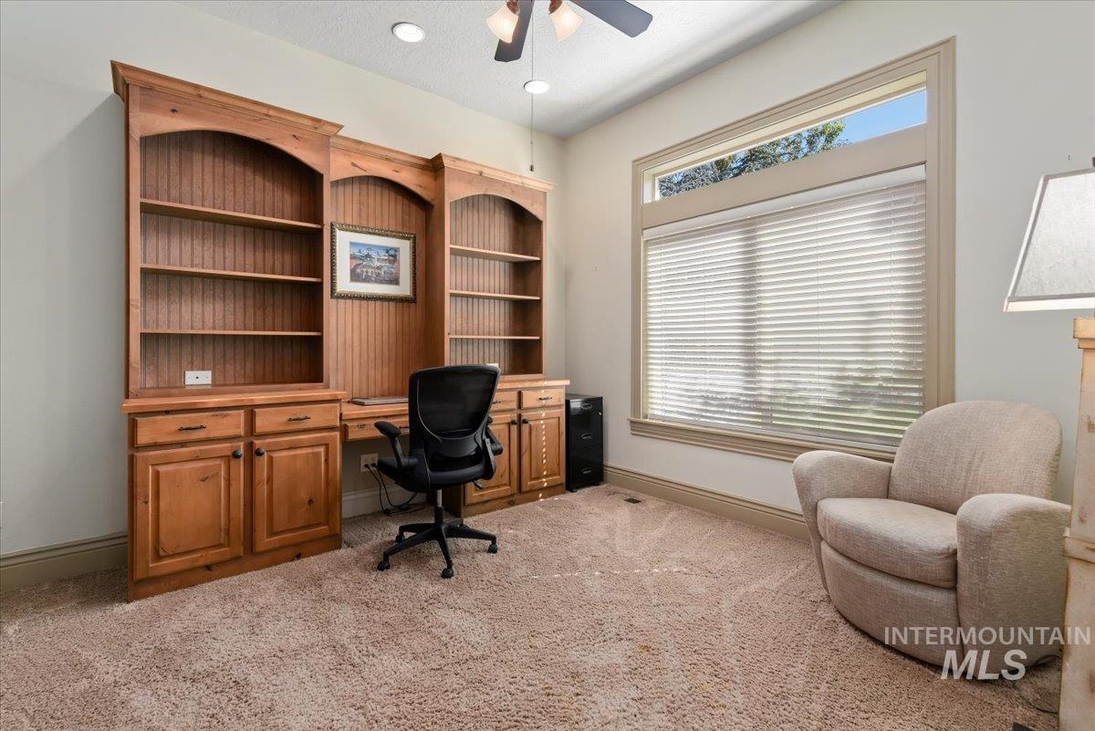 Office area with light carpet, a ceiling fan, a textured ceiling, and recessed lighting