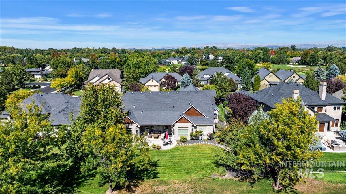 Aerial view of residential area featuring a tree filled landscape