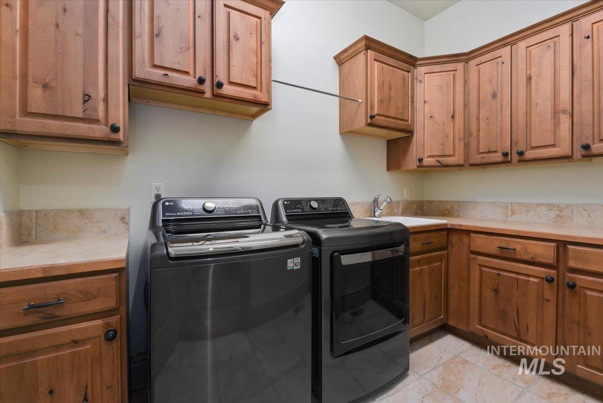 Laundry room featuring cabinet space and washing machine and clothes dryer