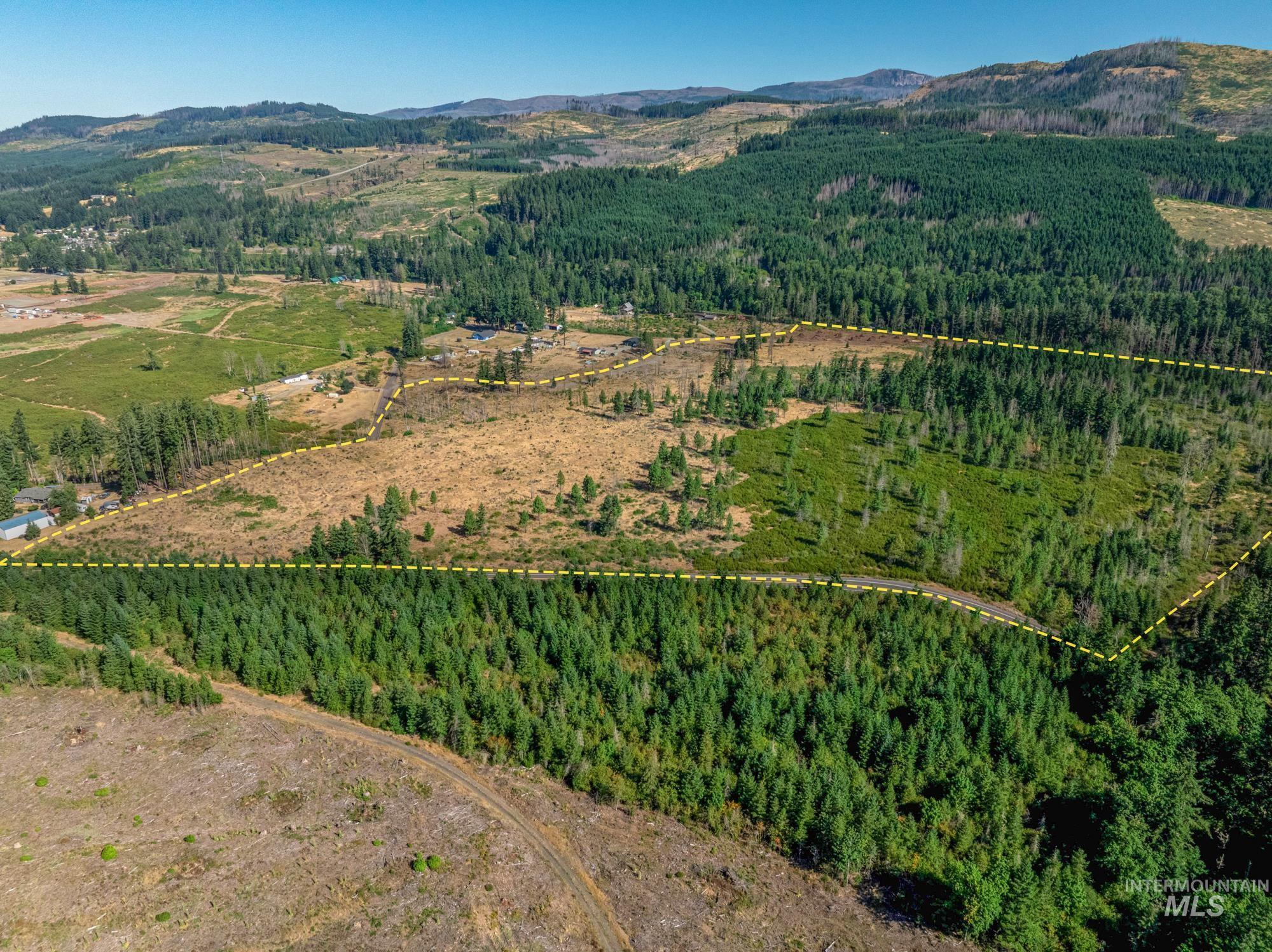 Aerial view of property and surrounding area featuring property parcel outlined