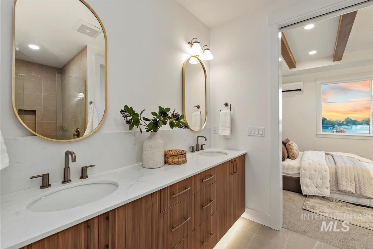 Full bath with recessed lighting, light tile patterned flooring, double vanity, ensuite bathroom, and tiled shower