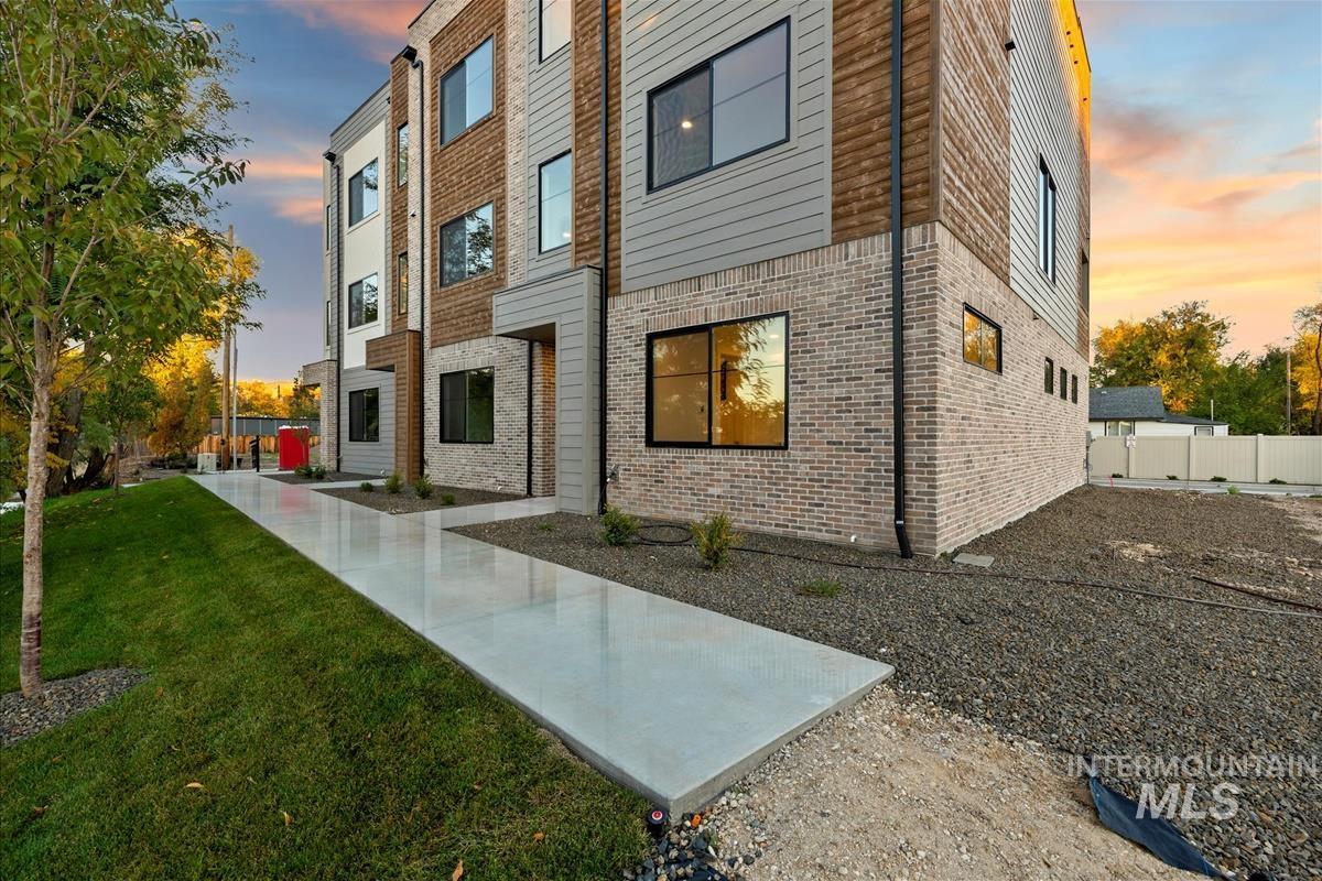 Property exterior at dusk featuring brick siding